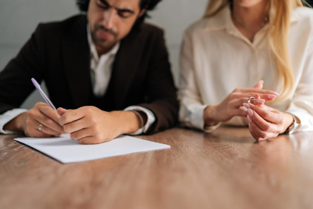 Spouses couple signing decree papers