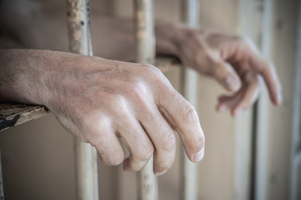 Prisoner hands in a jail