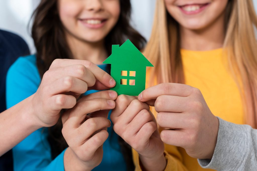 Kids holding toy house