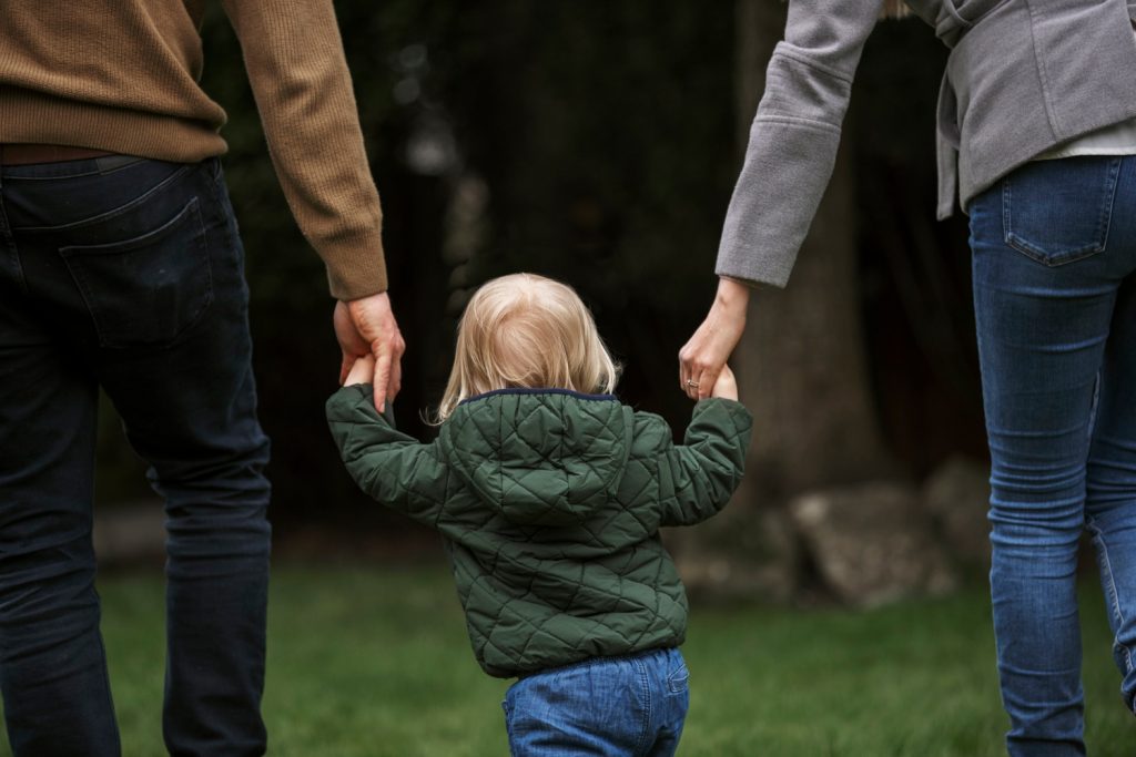 Parents walking with kid in park