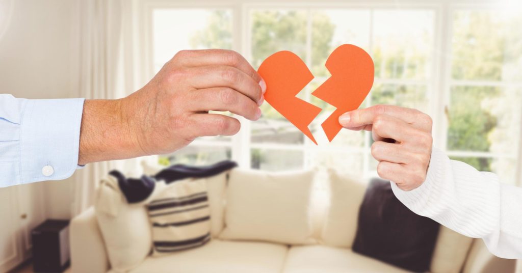 Hand of couple holding broken hearts