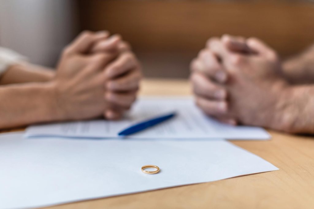 Divorce papers and ring on table