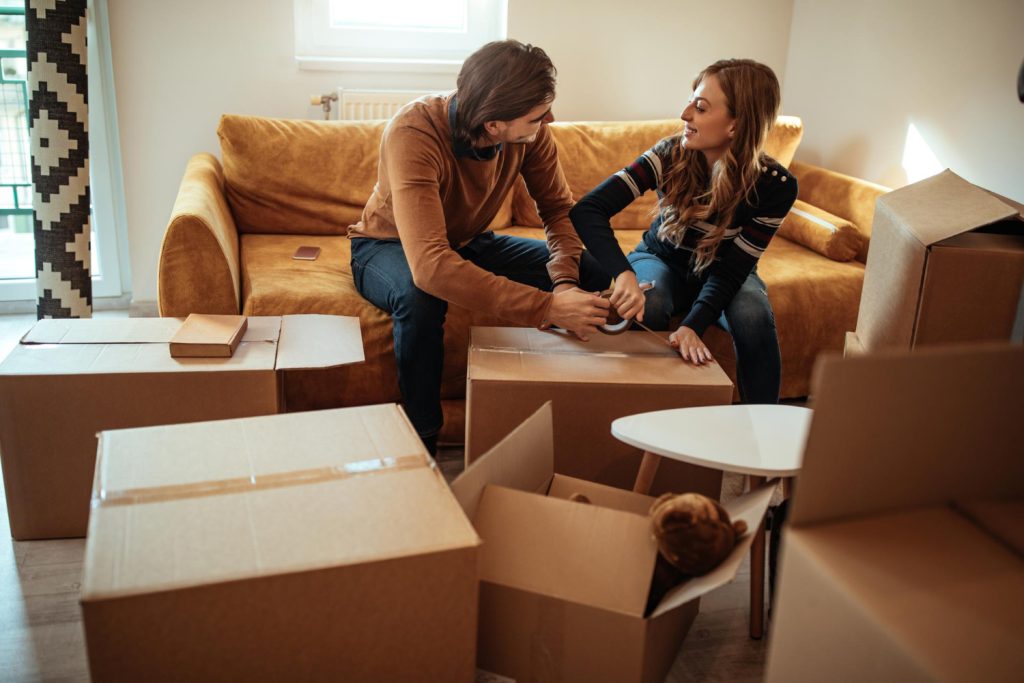 Couple packing boxes for moving